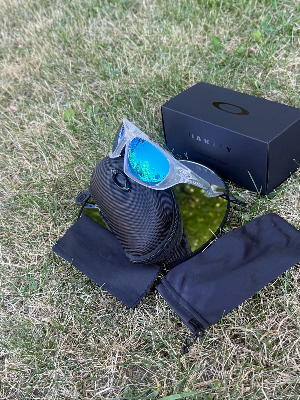 Oakley Clear Frame Sunglasses with Blue-Green Mirrored Lenses